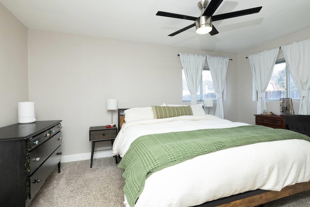 bedroom featuring light carpet, ceiling fan, and baseboards