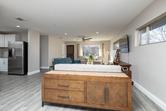 interior space featuring recessed lighting, light wood-type flooring, visible vents, and baseboards