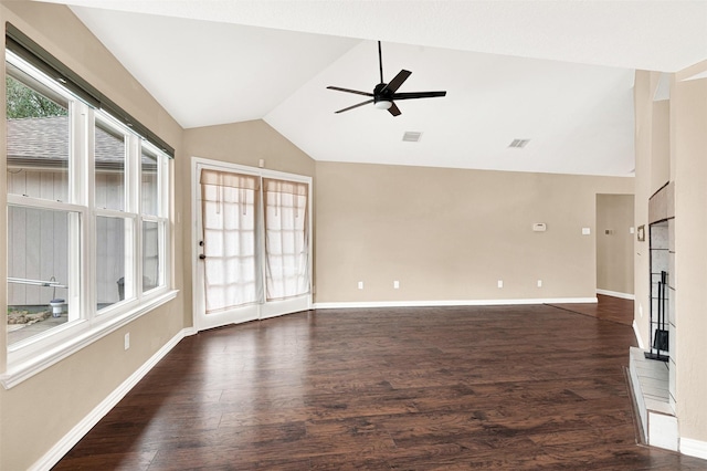 unfurnished living room featuring dark wood-style flooring, visible vents, a ceiling fan, vaulted ceiling, and baseboards