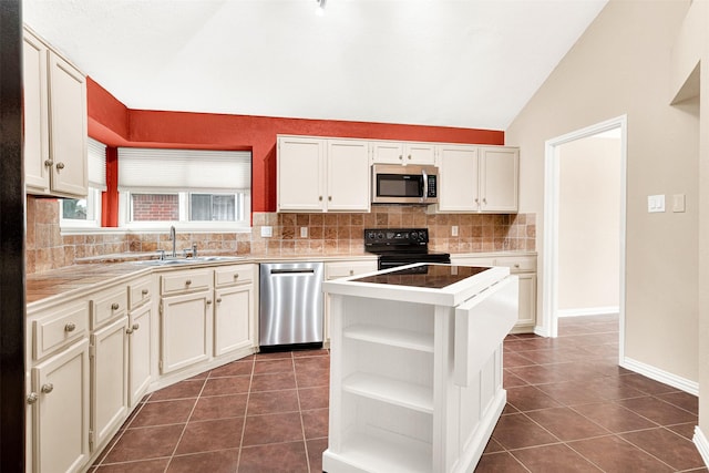 kitchen featuring lofted ceiling, dark tile patterned floors, appliances with stainless steel finishes, and open shelves