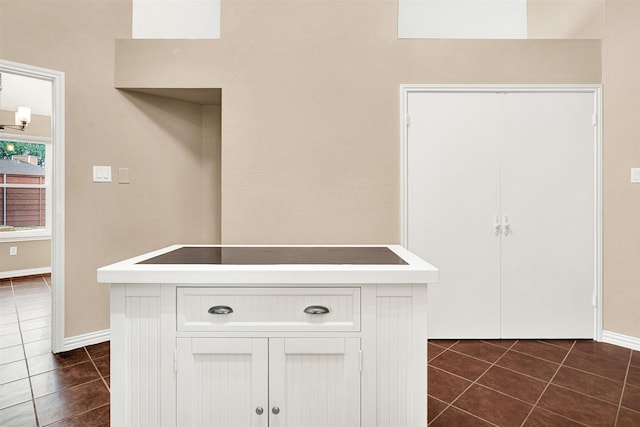 details with baseboards and black electric cooktop