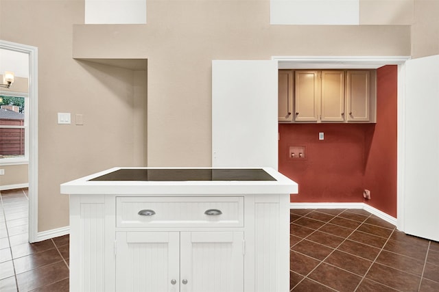 interior space featuring black electric stovetop and baseboards