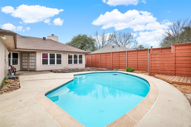 view of swimming pool with a patio area and a fenced backyard