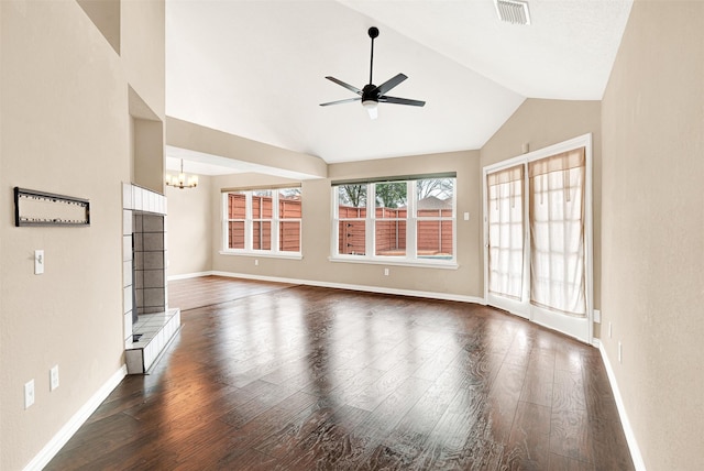 unfurnished living room featuring baseboards, visible vents, lofted ceiling, dark wood-style floors, and ceiling fan with notable chandelier