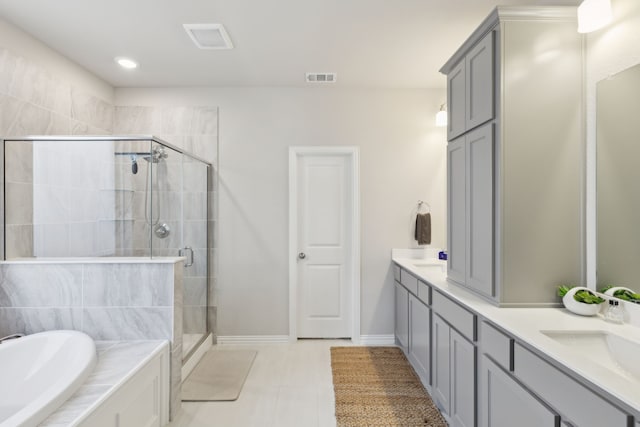 full bathroom featuring a garden tub, double vanity, a sink, and a shower stall