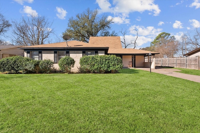 single story home featuring a patio, brick siding, fence, concrete driveway, and a front lawn