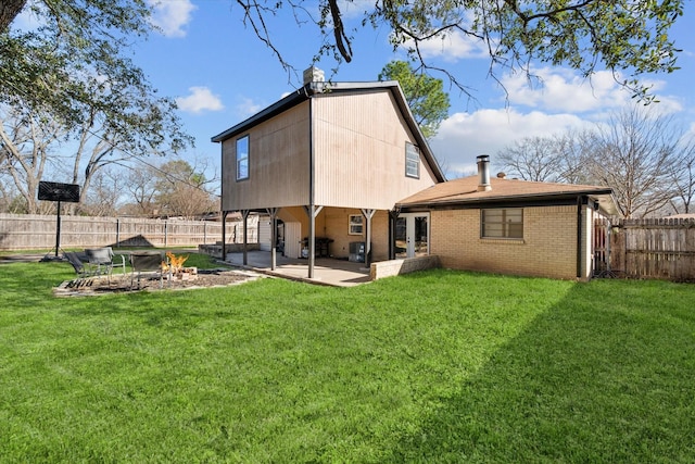 rear view of property with a patio area, a fenced backyard, a lawn, and brick siding