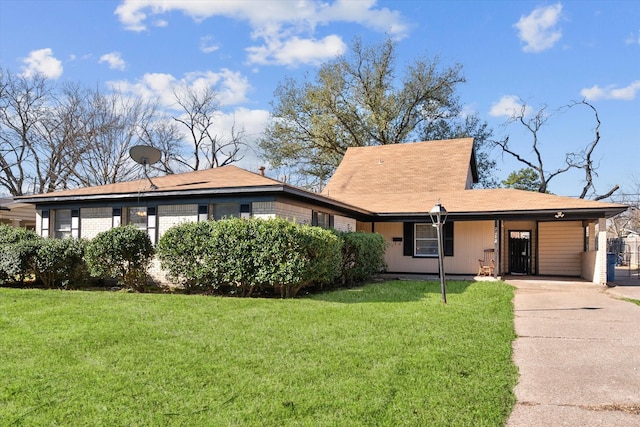 ranch-style home with concrete driveway, brick siding, and a front lawn