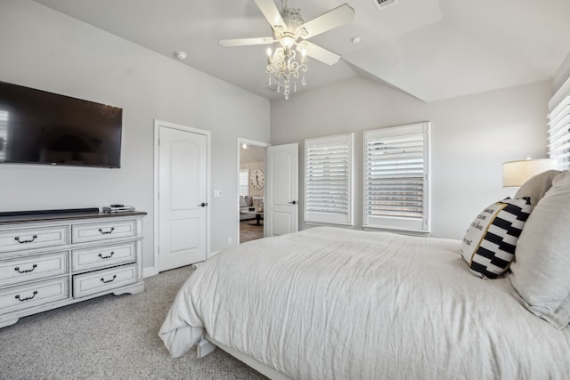 carpeted bedroom featuring vaulted ceiling, multiple windows, visible vents, and a ceiling fan