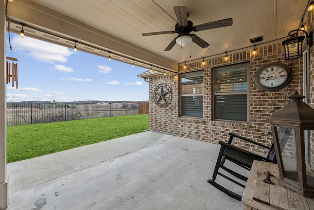 view of patio with fence and a ceiling fan