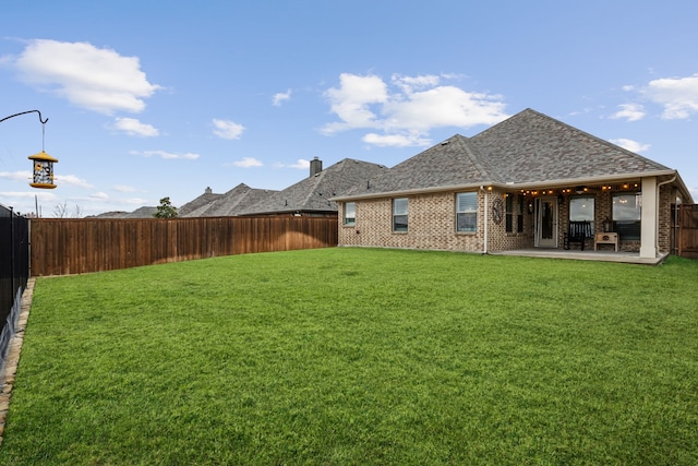 view of yard featuring a patio area and a fenced backyard