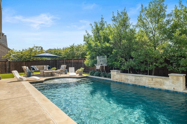 view of swimming pool with a fenced in pool, a patio area, a fenced backyard, and an outdoor hangout area