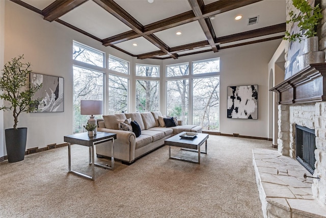 carpeted living area featuring coffered ceiling, visible vents, a fireplace, and beamed ceiling