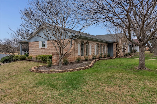 view of side of property with a lawn and brick siding