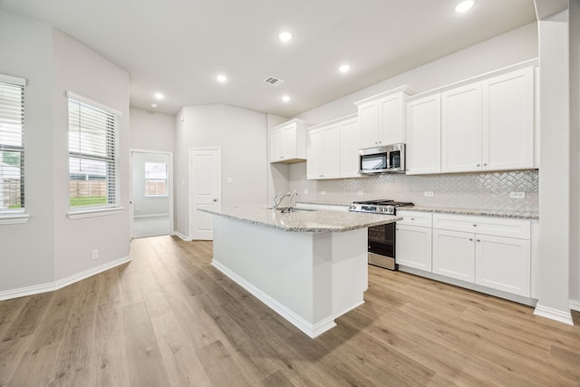 2013 Forest Wood, Mesquite, TX 75181 - kitchen featuring appliances with stainless steel finishes, backsplash, white cabinets, light wood-style flooring, and recessed lighting
