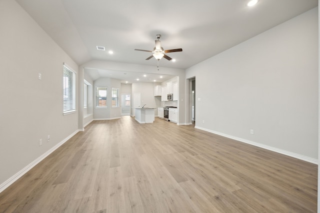2013 Forest Wood, Mesquite, TX 75181 - unfurnished living room featuring a ceiling fan, recessed lighting, light wood-style flooring, baseboards, and lofted ceiling