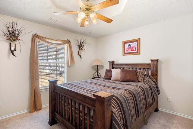 bedroom with carpet, ceiling fan, a textured ceiling, and baseboards