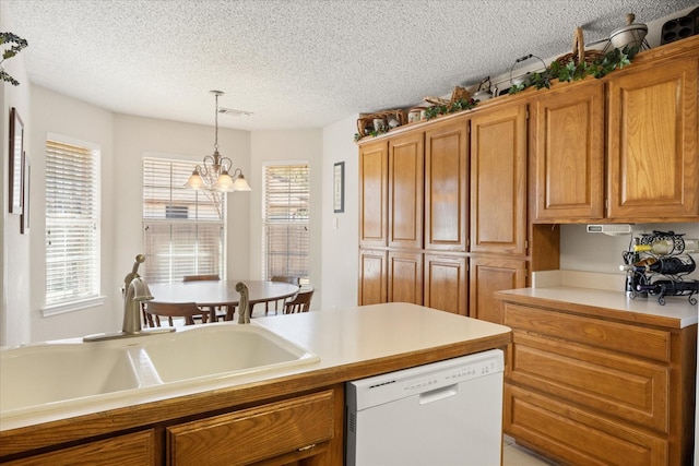 kitchen featuring brown cabinetry, dishwasher, and a sink