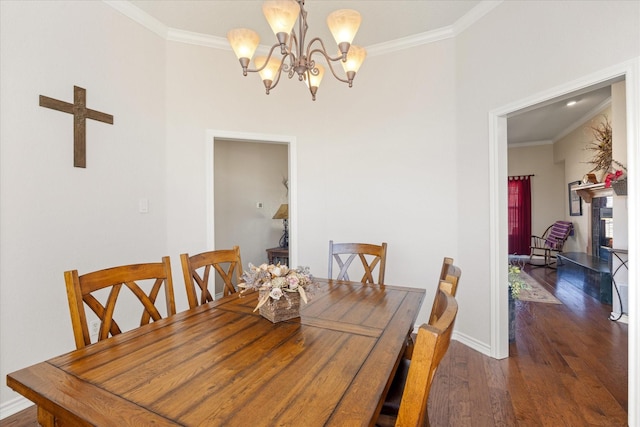 dining room featuring ornamental molding, baseboards, an inviting chandelier, and wood finished floors