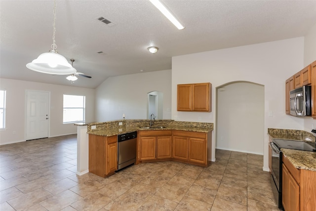 kitchen with appliances with stainless steel finishes, brown cabinets, visible vents, and a sink