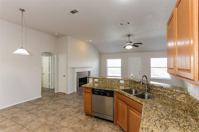 kitchen with dishwasher, arched walkways, a sink, and visible vents