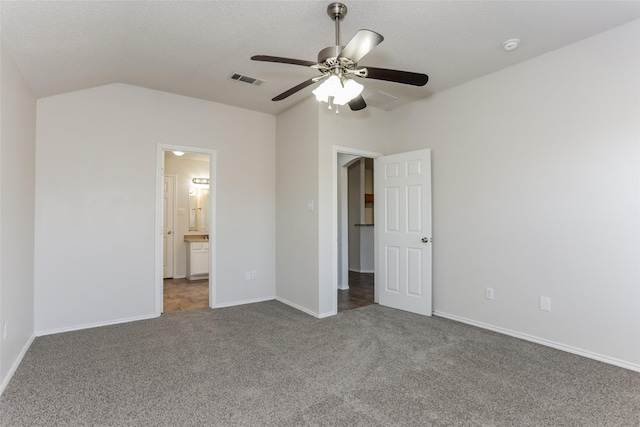 unfurnished bedroom with lofted ceiling, carpet flooring, a ceiling fan, visible vents, and baseboards