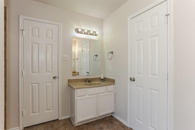 bathroom with vanity and baseboards