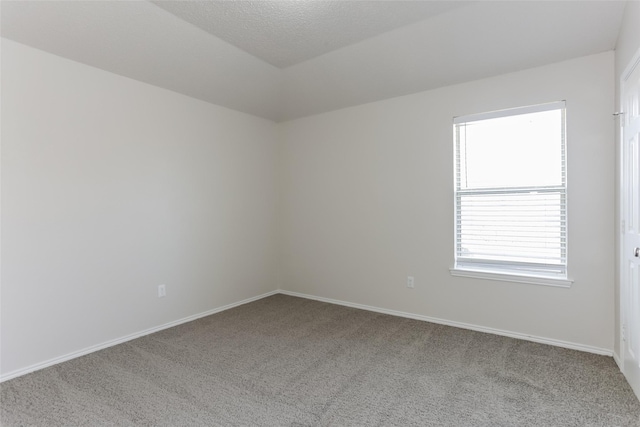 carpeted empty room with baseboards