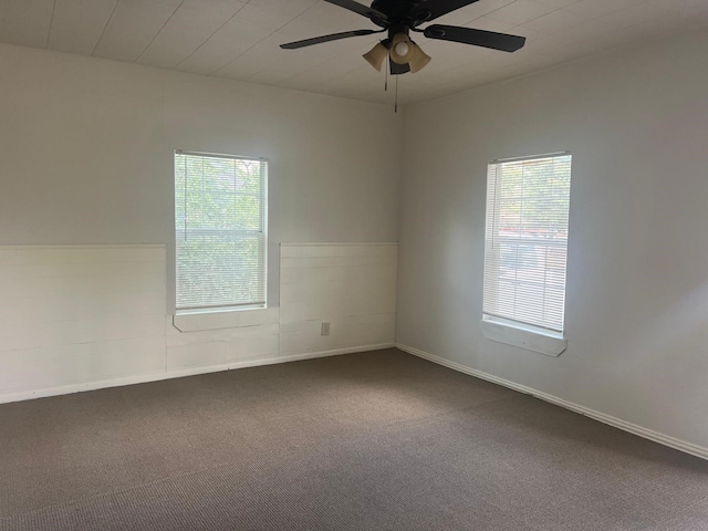 unfurnished room with carpet floors and a ceiling fan