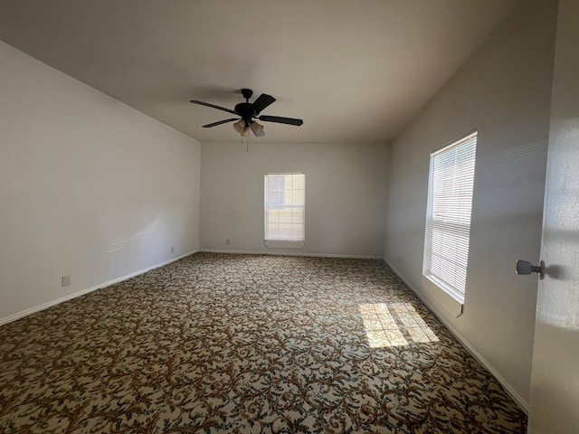 carpeted spare room with a wealth of natural light and baseboards