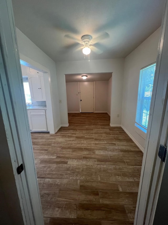 interior space featuring baseboards and wood finished floors