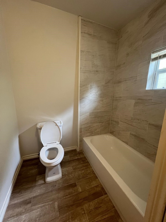 full bath featuring baseboards, toilet, and wood finished floors