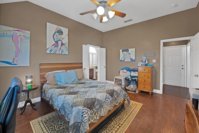 bedroom featuring a ceiling fan, baseboards, visible vents, and wood finished floors