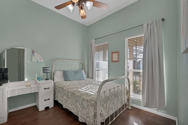 bedroom featuring dark wood finished floors, a ceiling fan, and baseboards