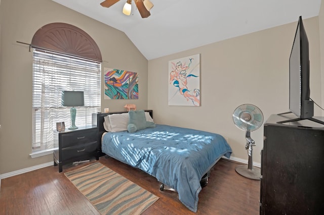 bedroom featuring vaulted ceiling, wood finished floors, a ceiling fan, and baseboards