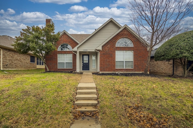 traditional-style home with a front yard and brick siding