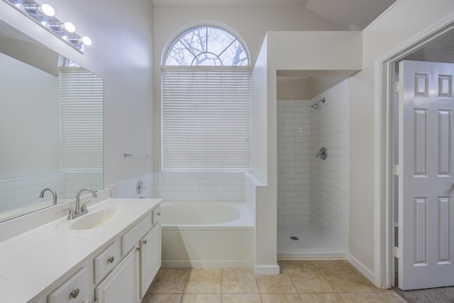 full bathroom featuring a bath, tiled shower, vanity, and tile patterned floors