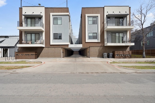 exterior space with brick siding and stucco siding