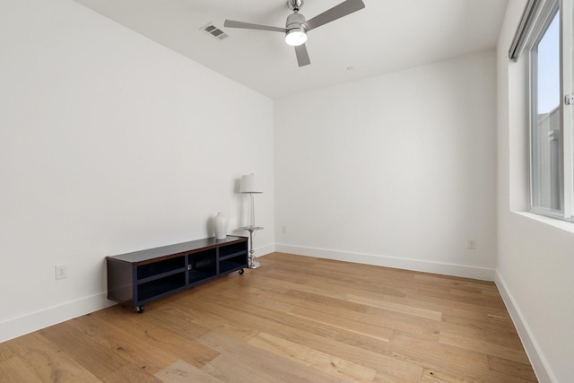 unfurnished room with visible vents, baseboards, and wood finished floors