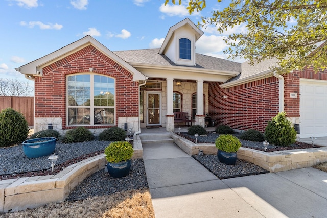 view of front of home with covered porch, stone siding, and brick siding