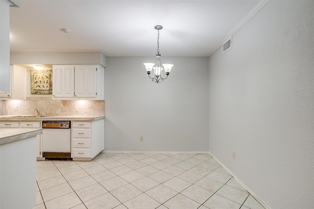 kitchen with white dishwasher, visible vents, white cabinets, light countertops, and decorative backsplash