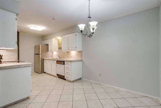 kitchen featuring light countertops, freestanding refrigerator, dishwasher, tasteful backsplash, and crown molding