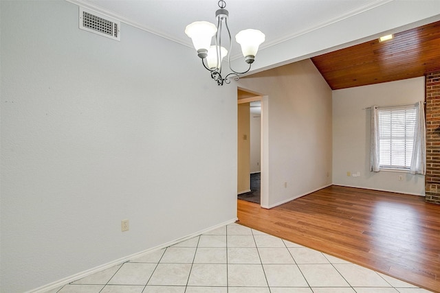 spare room with light tile patterned floors, visible vents, wood ceiling, crown molding, and a notable chandelier