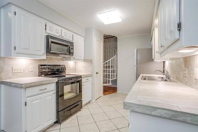 kitchen featuring black electric range, crown molding, light tile patterned floors, light countertops, and a sink