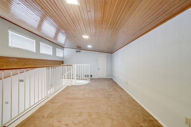 unfurnished room featuring crown molding, lofted ceiling, visible vents, light carpet, and wooden ceiling