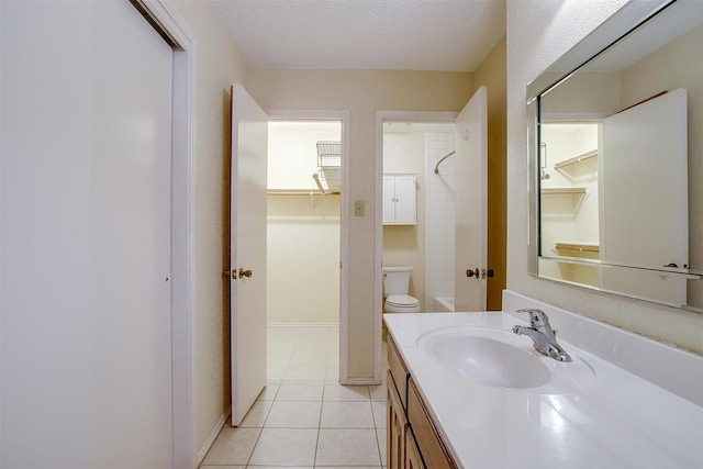 bathroom with baseboards, toilet, tile patterned flooring, a textured ceiling, and vanity