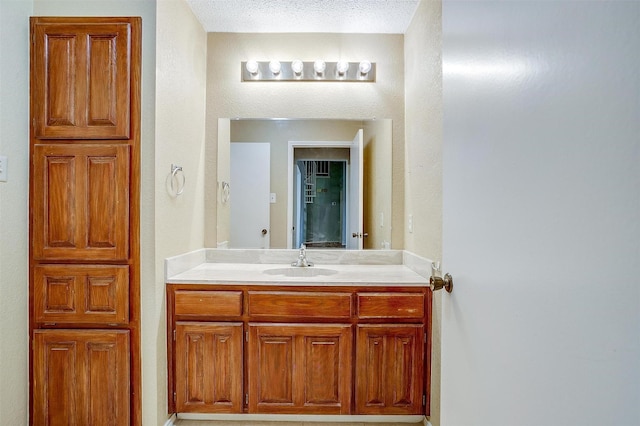 bathroom featuring vanity and a textured ceiling