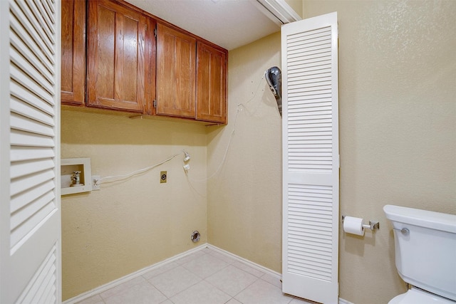 washroom with laundry area, light tile patterned floors, baseboards, and electric dryer hookup