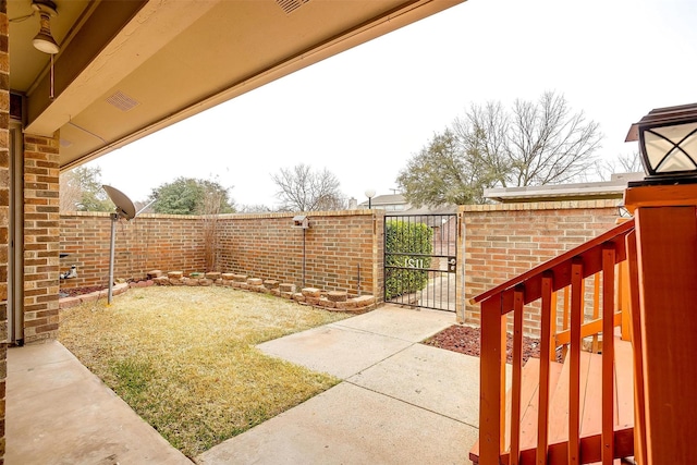 view of yard featuring a fenced backyard and a gate