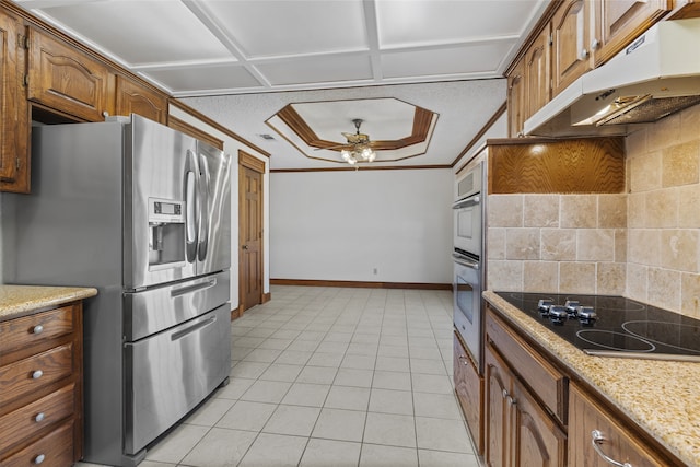 kitchen with stainless steel fridge, ornamental molding, black electric stovetop, under cabinet range hood, and backsplash